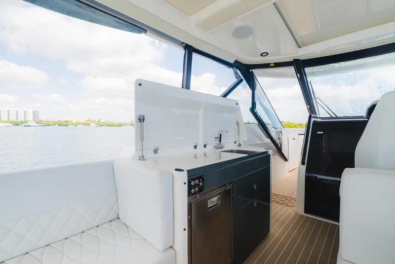 Slide: The Image of 2024 Saxdor 400 GTO interior with modern kitchenette and seating, overlooking water. - 21