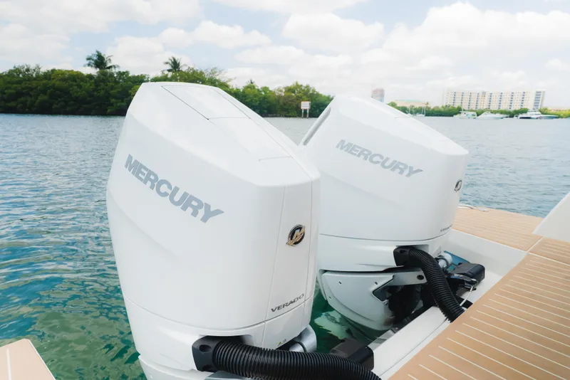 Slide: The Image of Twin Mercury outboard engines on a 2024 Saxdor 400 GTO, docked by the water. - 32