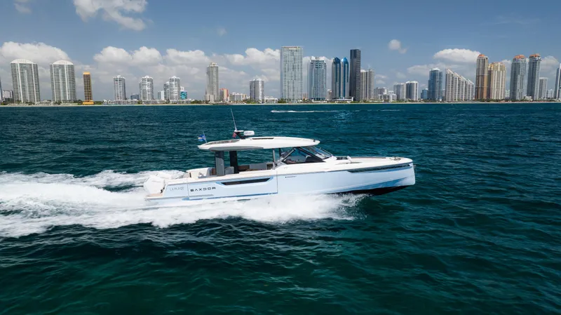 Slide: The Image of 2024 Saxdor 400 GTO cruising on ocean with city skyline in background. - 43