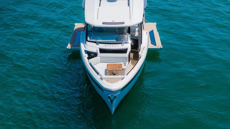 Slide: The Image of 2024 Saxdor 400 GTO boat on clear blue water, aerial view. - 5