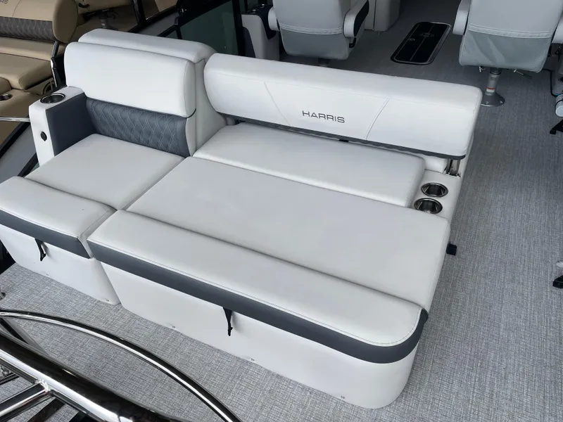 Slide: The Image of Luxurious seating on 2025 Harris SUNLINER 230 SLDH pontoon boat, featuring cup holders and sleek design. - 11