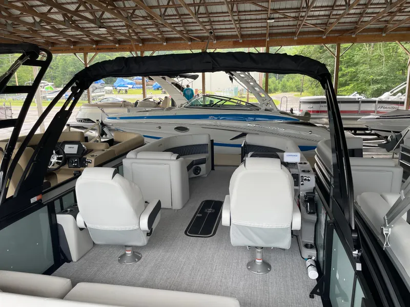Slide: The Image of 2025 Harris SUNLINER 230 SLDH pontoon boat interior with modern seating under a wooden canopy. - 12