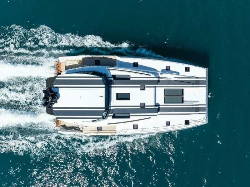 Slide: The Image of Aerial view of 2026 McConaghy MC63P yacht cruising on blue ocean waters. - 10