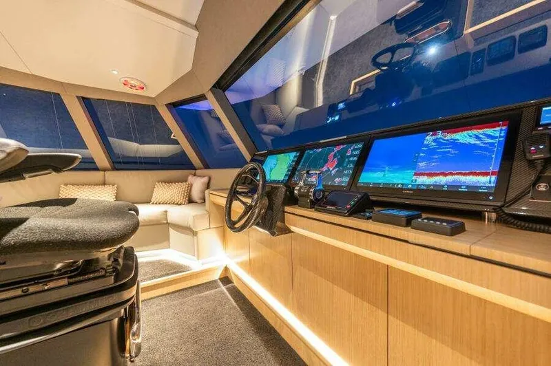 Slide: The Image of Luxurious interior of 2026 McConaghy MC63P yacht with modern navigation system and plush seating. - 15