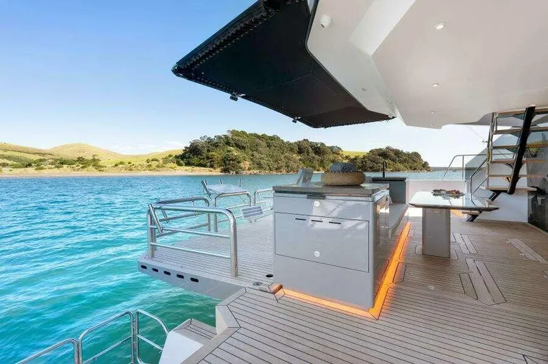 Slide: The Image of Luxurious McConaghy MC63P yacht deck with modern amenities, overlooking serene blue waters. - 21