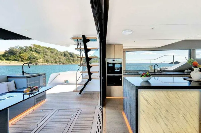 Slide: The Image of Luxurious 2026 McConaghy MC63P yacht interior with modern kitchen and scenic ocean view. - 23