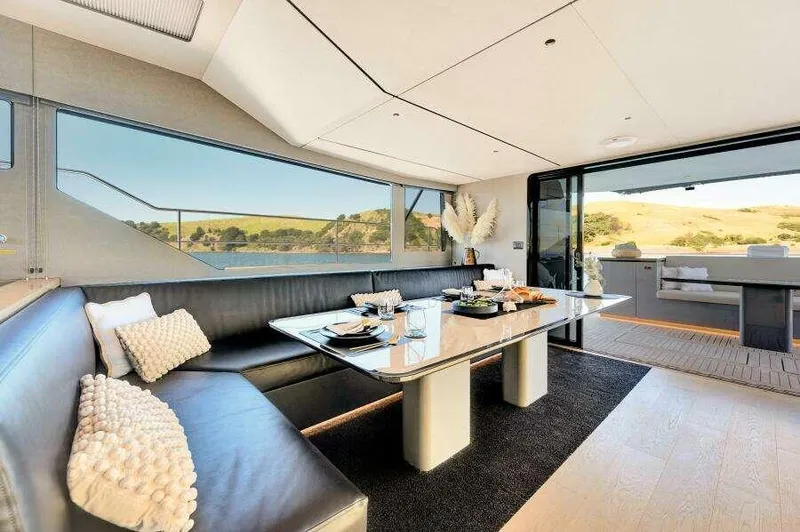 Slide: The Image of Luxurious interior of 2026 McConaghy MC63P yacht with elegant dining area and scenic views. - 26