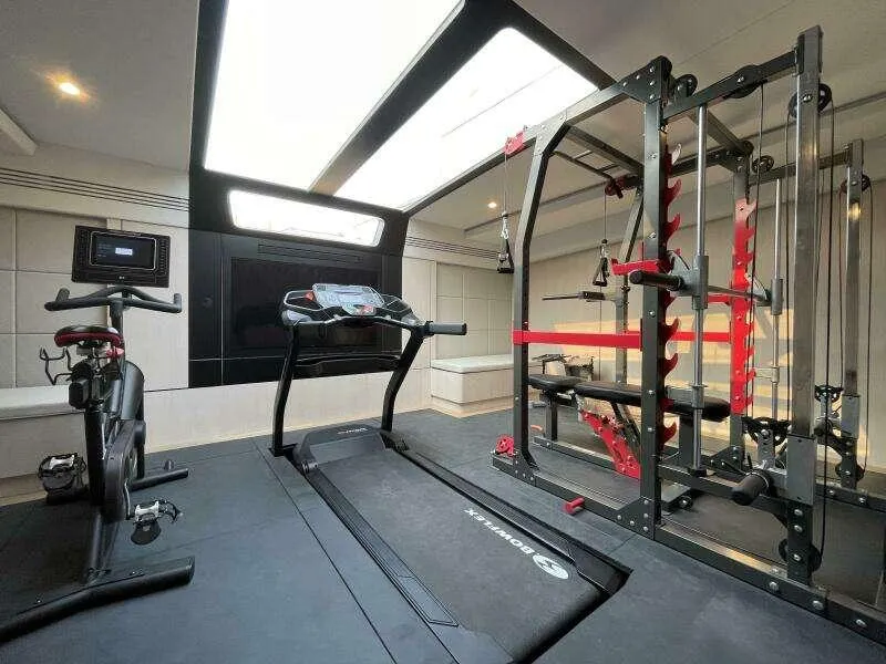 Slide: The Image of Luxury yacht gym with treadmill, exercise bike, and weight machine on McConaghy MC63P, 2026 model. - 33