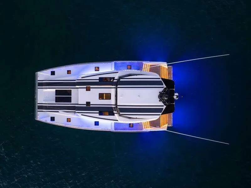 Slide: The Image of Aerial view of 2026 McConaghy MC63P yacht with illuminated deck and sleek design. - 6