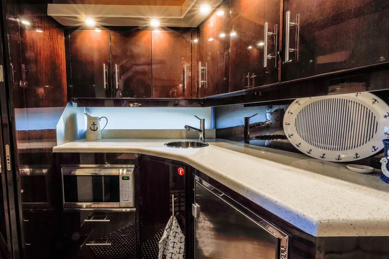 Slide: The Image of Galley with elegant cabinetry, sink, stove top and microwave/convection oven - 11