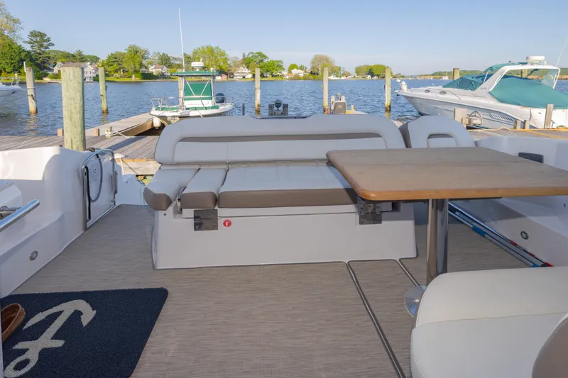 Slide: The Image of Cockpit with additional seating, table, aft-facing sun pad, and grill - 20