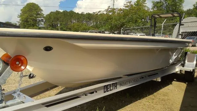 Slide: The Image of 2025 Xplor D18 Guide boat on Delta Boatworks trailer, parked outdoors. - 13