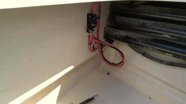 Slide: The Image of Interior wiring of 2025 Xplor D18 Guide (Tiller) boat, featuring red and black cables. - 9