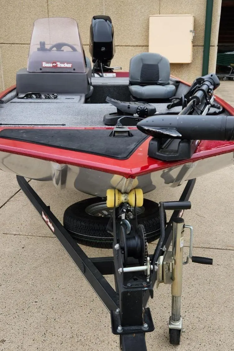 Slide: The Image of 2021 Tracker Bass Tracker Classic XL boat on trailer, featuring red accents and fishing equipment. - 3