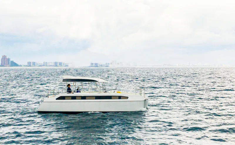 Slide: The Image of Electric catamaran Smart Cat E280 sailing on open water, 2025 model. - 1