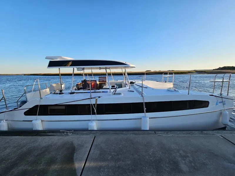 Slide: The Image of Modern Smart Cat E280 Electric catamaran docked by the water, 2025 model. - 9