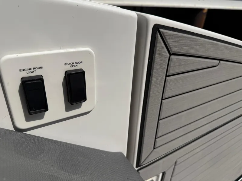 Slide: The Image of Control panel on 2021 Cruisers Yachts 38 GLS OB, featuring engine room light and beach door switches. - 10
