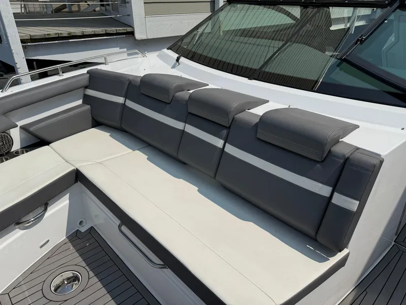 Slide: The Image of 2021 Cruisers Yachts 38 GLS OB interior seating with gray and white upholstery. - 13