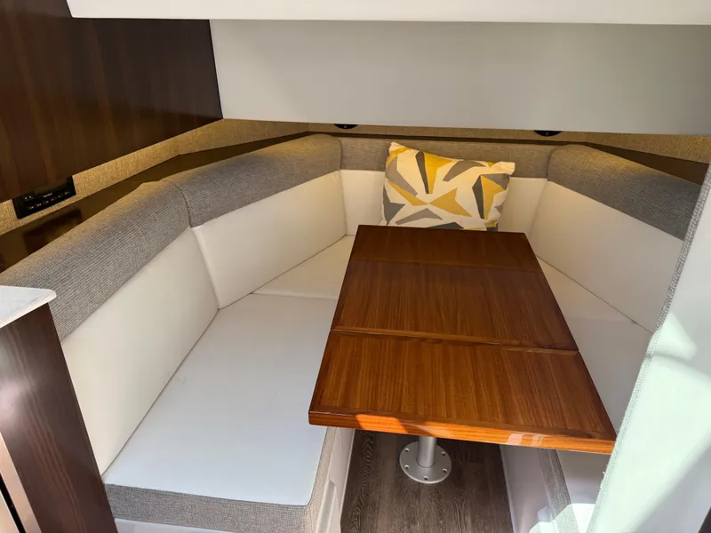 Slide: The Image of 2021 Cruisers Yachts 38 GLS OB interior with cozy seating and wooden table. - 14