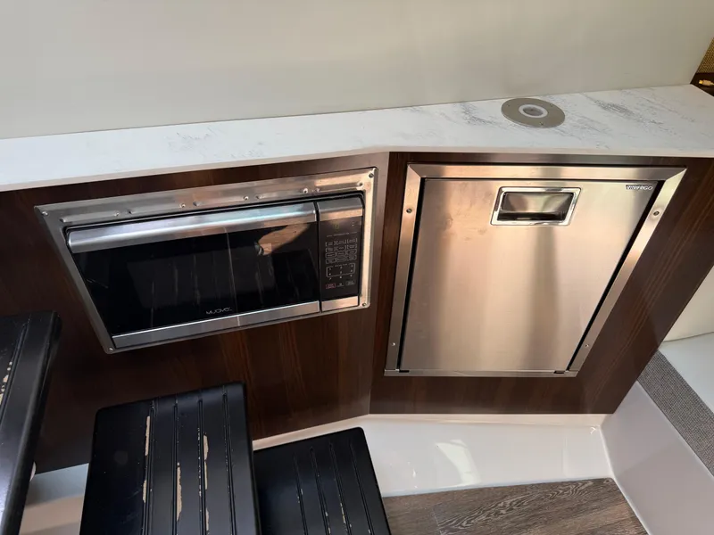 Slide: The Image of 2021 Cruisers Yachts 38 GLS OB interior with microwave and stainless steel appliance. - 15