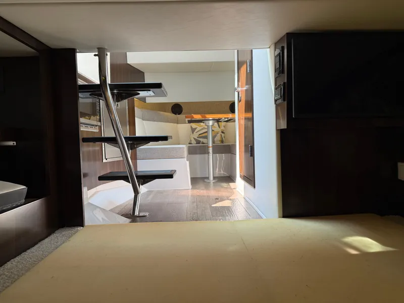 Slide: The Image of Interior view of 2021 Cruisers Yachts 38 GLS OB, featuring modern staircase and cozy cabin. - 16