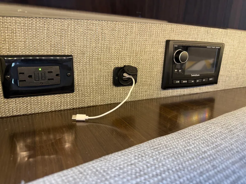 Slide: The Image of Power outlet and audio system on 2021 Cruisers Yachts 38 GLS OB interior. - 21