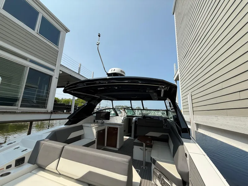 Slide: The Image of 2021 Cruisers Yachts 38 GLS OB docked, showcasing sleek design and spacious seating. - 22