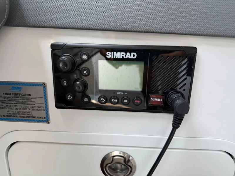 Slide: The Image of Simrad marine radio on 2021 Cruisers Yachts 38 GLS OB dashboard. - 24