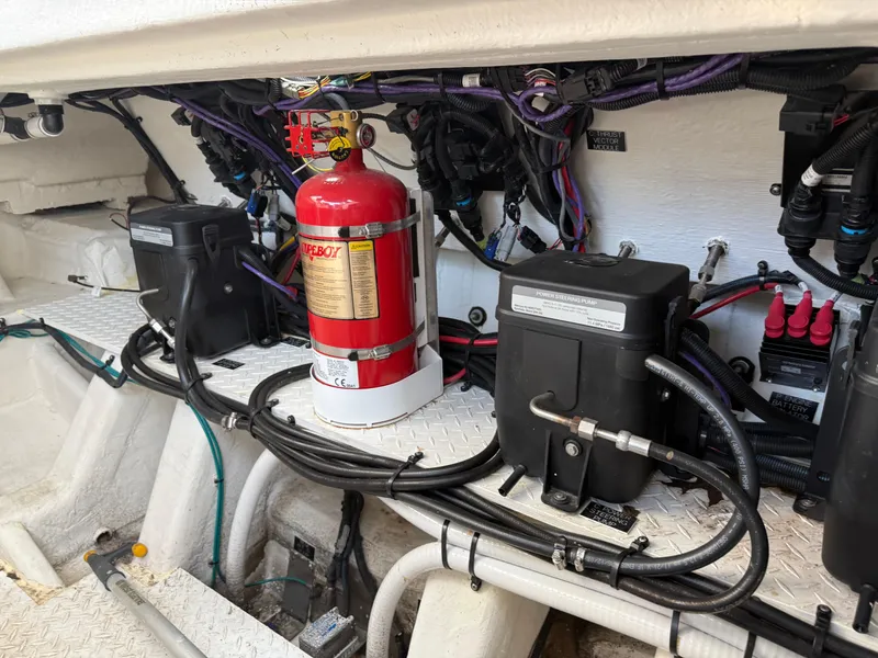Slide: The Image of Engine compartment of 2021 Cruisers Yachts 38 GLS OB with fire extinguisher and wiring. - 28