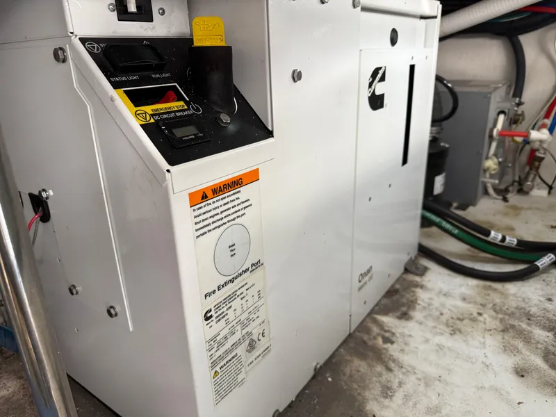 Slide: The Image of Engine compartment of 2021 Cruisers Yachts 38 GLS OB with Cummins generator and safety warnings. - 30