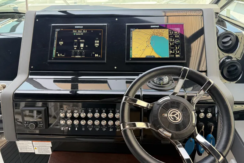 Slide: The Image of Dashboard of 2021 Cruisers Yachts 38 GLS OB with navigation screens and controls. - 37