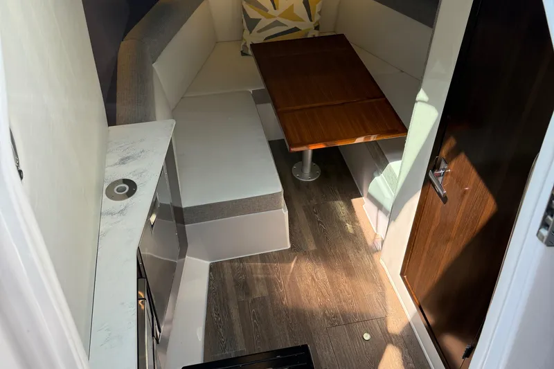 Slide: The Image of Interior of 2021 Cruisers Yachts 38 GLS OB with seating and wooden table. - 39