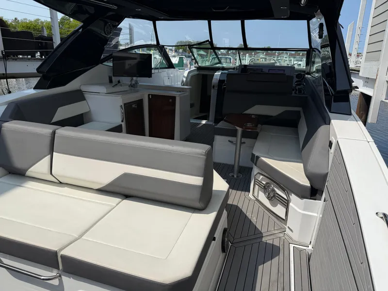 Slide: The Image of 2021 Cruisers Yachts 38 GLS OB interior with modern seating and sleek design. - 4