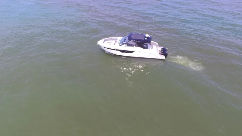 Slide: The Image of 2021 Cruisers Yachts 38 GLS OB boat cruising on open water. - 43