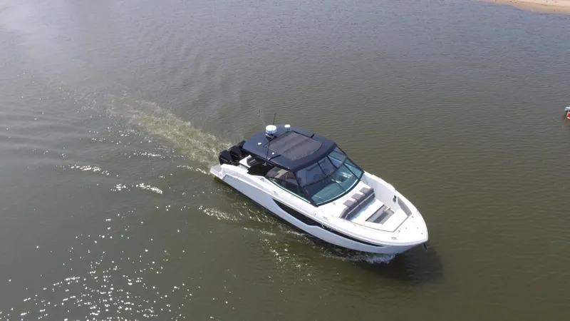 Slide: The Image of 2021 Cruisers Yachts 38 GLS OB cruising on calm water, aerial view. - 47
