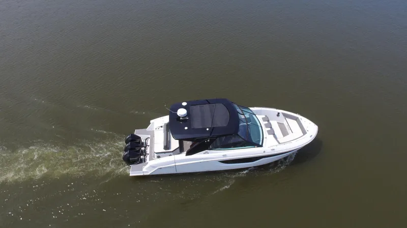 Slide: The Image of 2021 Cruisers Yachts 38 GLS OB cruising on calm water, aerial view. - 48