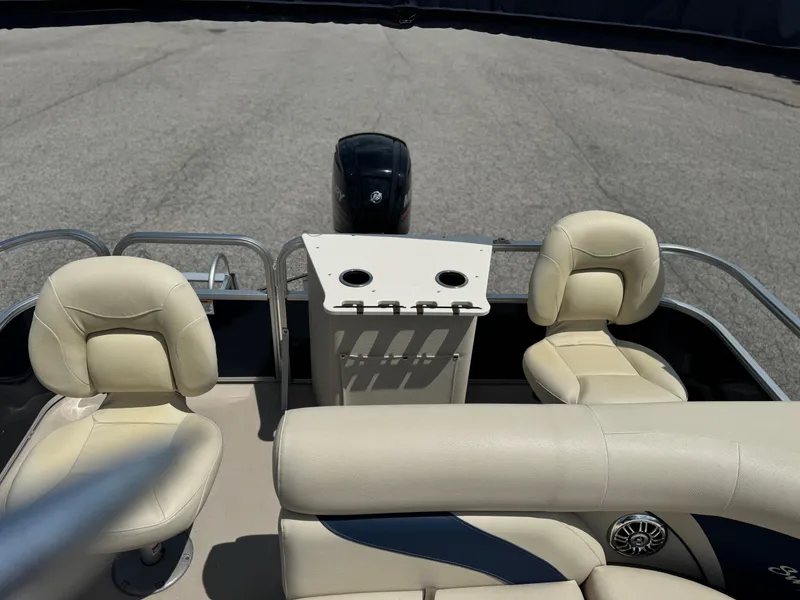 Slide: The Image of 2014 SunChaser Classic Cruise 8520 boat interior with beige seating and cup holders. - 7