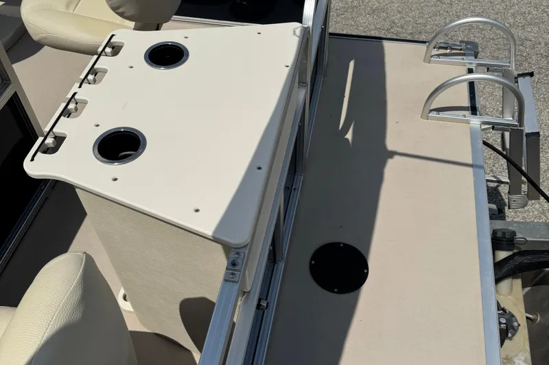 Slide: The Image of 2014 SunChaser Classic Cruise 8520 boat interior with cup holders and seating. - 8