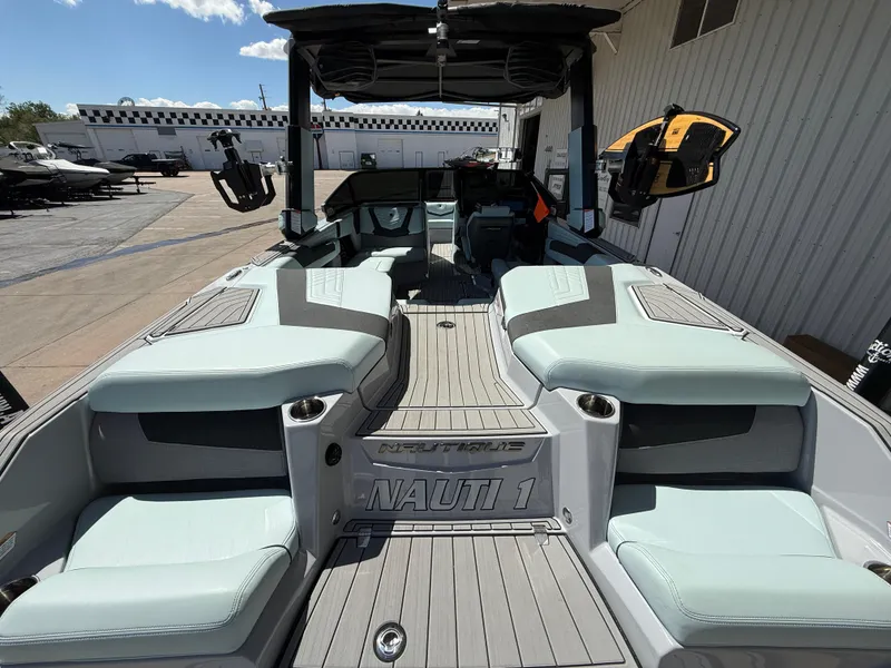 Slide: The Image of 2023 Nautique Super Air G23 boat interior with cushioned seating and sleek design. - 10