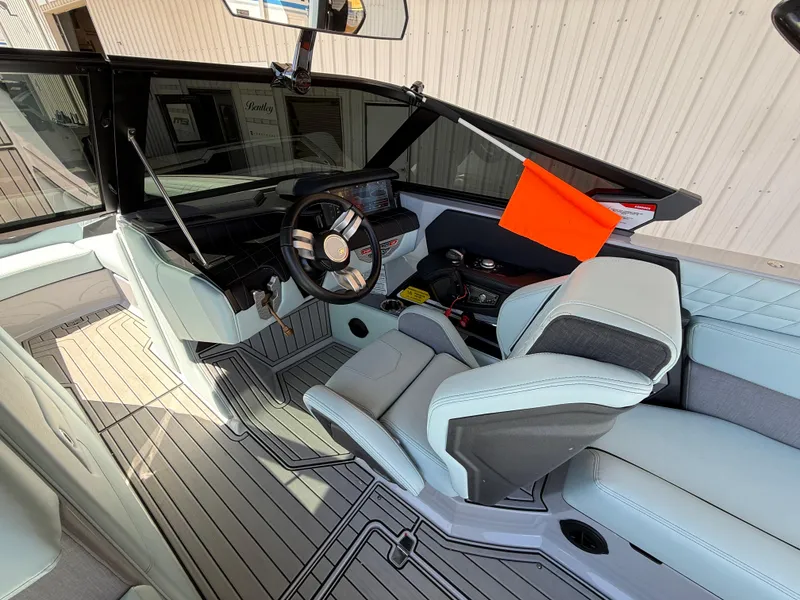 Slide: The Image of 2023 Nautique Super Air G23 interior with modern helm, luxury seating, and sleek design. - 12