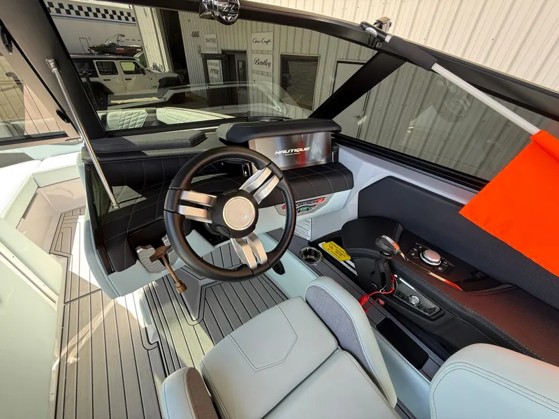 Slide: The Image of 2023 Nautique Super Air G23 boat interior with steering wheel and dashboard. - 13