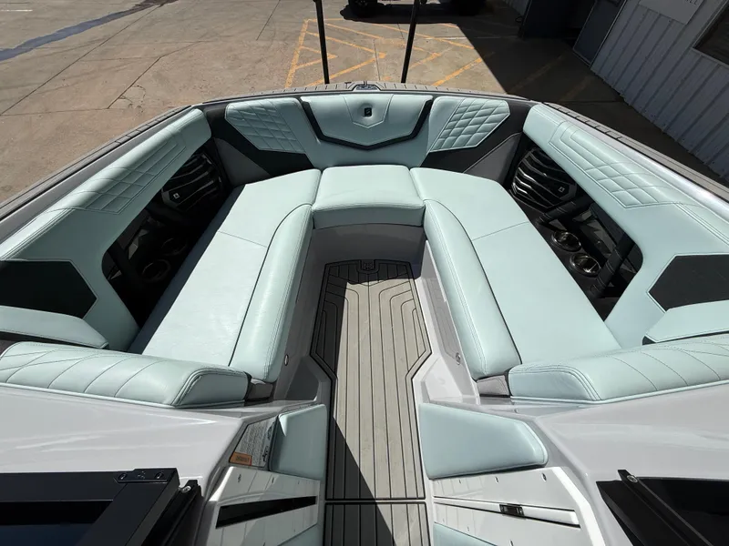Slide: The Image of 2023 Nautique Super Air G23 boat interior with light blue seating and modern design. - 14