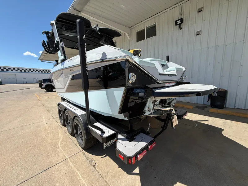 Slide: The Image of 2023 Nautique Super Air G23 boat on a trailer, parked outside a building. - 9