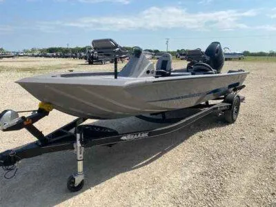 Slide: The Image of 2025 SeaArk Flex 19 Pro boat on trailer, parked outdoors on gravel. - 3