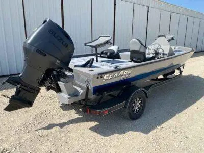 Slide: The Image of 2025 SeaArk Flex 19 Pro boat with Suzuki outboard motor, parked on a trailer. - 6