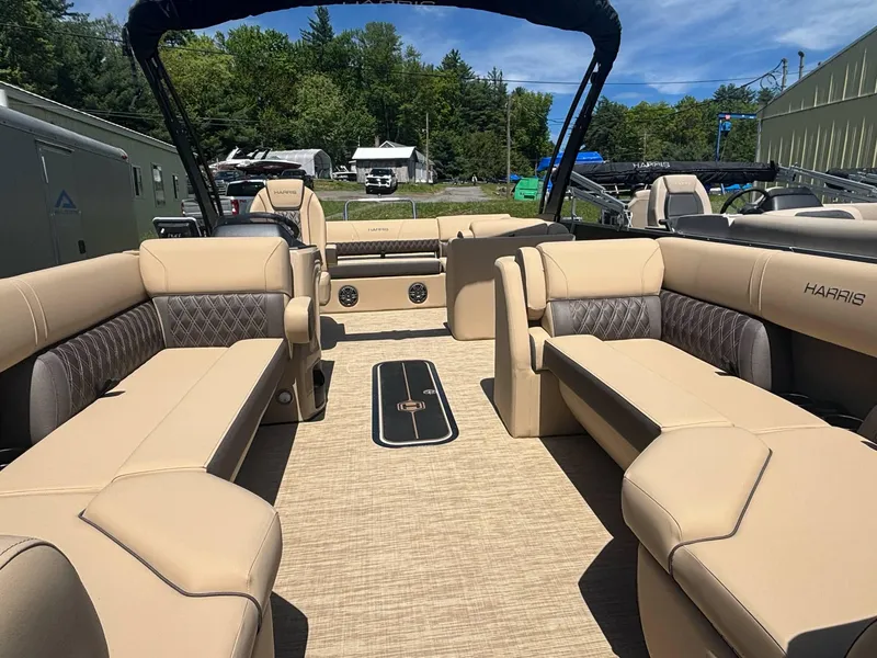 Slide: The Image of 2025 Harris Sunliner 230 SL pontoon boat with spacious beige seating and modern design. - 4