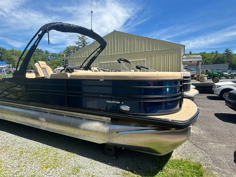 Slide: The Image of 2025 Harris Sunliner 230 SL pontoon boat parked outdoors on a sunny day. - 5