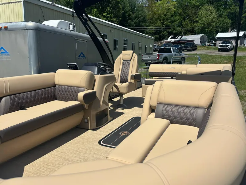 Slide: The Image of Luxurious interior of 2025 Harris Sunliner 230 SL pontoon boat with beige seating. - 6
