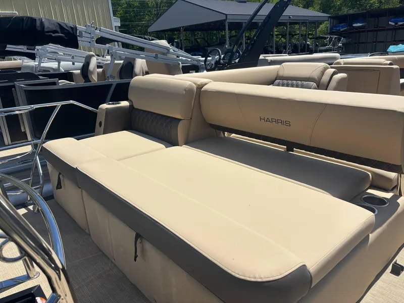 Slide: The Image of 2025 Harris Sunliner 230 SL pontoon boat with beige seating, outdoor setting. - 8