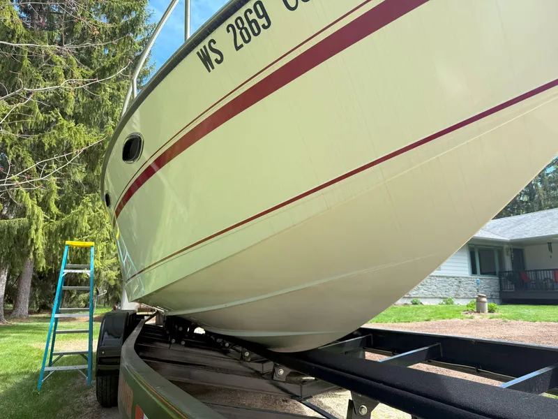 Slide: The Image of 1988 Slickcraft 268 SC boat on trailer, side view with registration number visible. - 10